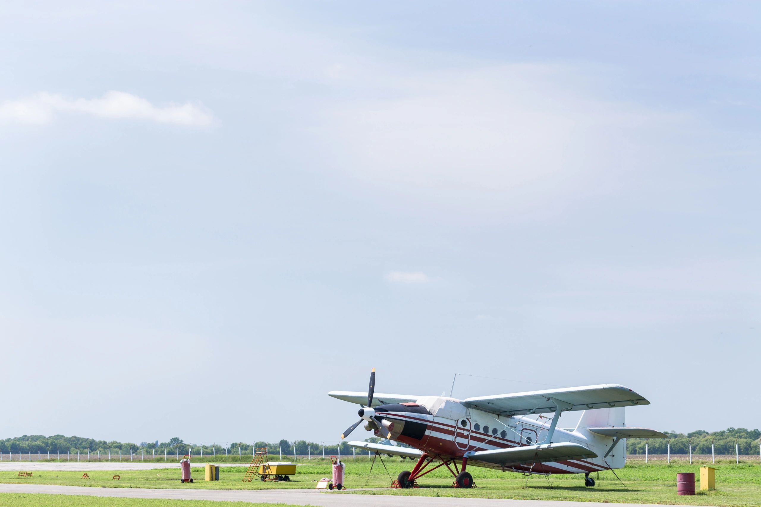 Piston airplane parked on the ramp at a small airport