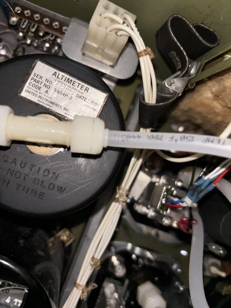 Altimeter and Tubing behind Aircraft Panel